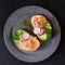 Sandwiches with smoked pink salmon, radish, cucumber and cream cheese on gray ceramic plate and textile background. Traditional Sc