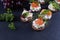 Sandwiches of smoked salmon, shrimp, dill and sauce on the table, near grapes