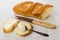 Sandwiches with sweet melted cheese, spoon, loaf of bread