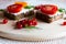 Sandwiches with tomato and herbs and berries