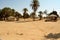 Sandy area in Egypt with alcoves and palm trees on a sunny day