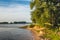 Sandy bank of a wide Dutch river with a groyne