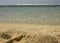 A sandy beach with blurry ocean at the background