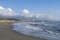 Sandy beach with breaking waves. Marinella di Sarzana looking towards Marina di Carrara. Mediterranean Sea, Europe