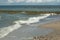 Sandy beach with breakwaters on the background of the sea1