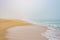 Sandy beach coast in fog, sea wave foam ocean romantic