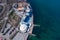 Sandy beach, concrete pier, clear sea water. Helicopter view