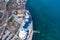 Sandy beach, concrete pier, clear sea water. Helicopter view