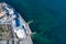 Sandy beach, concrete pier, clear sea water. Helicopter view.