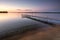 Sandy beach and dock beside lake at sunset. Minnesota, USA