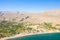 The sandy beach at the foot of the arid mountains , in Europe, Greece, Crete, Kato Zakros, By the Mediterranean Sea, in summer, on