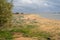 Sandy beach with grass growing in winter, just before a storm in Isla Cristina, Spain