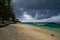 Sandy beach with moored Indonesian boats on the tropical island of Gili Meno. Heavy leaden clouds hung over the beach, a