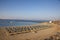 Sandy beach in the morning with sunloungers and parasols