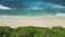 Sandy beach with ocean ocean waves in tropical island. Aerial view