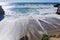 Sandy beach on the Pacific Ocean Coast during high tide and strong surf, Wilder Ranch State Park, California