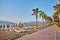 sandy beach without people and with sun loungers, folded umbrellas, palm trees, Turkey