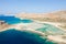 The sandy beach with pink reflections at the foot of the rocky cliffs, in Europe, Greece, Crete, Balos, By the Mediterranean Sea,