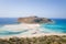 The sandy beach with pink reflections at the foot of the rocky cliffs, in Europe, Greece, Crete, Balos, By the Mediterranean Sea,