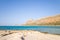 The sandy beach with pink reflections at the foot of the rocky cliffs, in Europe, Greece, Crete, Balos, By the Mediterranean Sea,