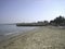 Sandy beach in quiet Sunny weather. Weak surf caressing the coastal sand