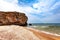 Sandy beach, rock. White ship on the turquoise water of the sea. Copy space.