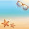 Sandy beach with starfish and sunglasses. Summer