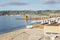 Sandy beach with sun loungers on the azure shore of the Mediterranean Sea. Preparation for the tourist season on a sunny day