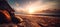 A sandy beach in the sunset, close to the shoreline, sun, sky, horizon, ocean waves and seascape.