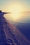 Sandy beach at sunset with footprints on the sand; faded, retro style