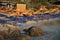 Sandy beach with thatched parasols and deck chairs