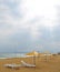 Sandy beach with umbrellas, deck chairs.