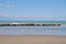 Sandy beach with wave breakers and blue sky. Room for copy space. Sciacca, Sicily, Italy.