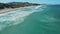 Sandy beach with waves in Brazil. Aerial view of Campeche beach, Florianopolis