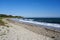 Sandy beach and waves with Nobska Light