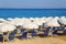 Sandy beach with white parasols and sunbeds