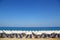 Sandy beach with white parasols and sunbeds