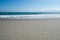 Sandy beachfront at Pikowai with patterns left in sand as water recedes