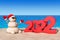 Sandy Christmas Snowman at Sunny Beach with 2022 New Year Sign. 3d Rendering