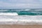 Sandy coast with great waves at Playa Cala Mesquida