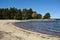 Sandy cove, blue lake, pine trees