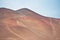 Sandy dune landscape Paracas peru on a sunny day with tire tracks