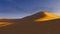 Sandy dunes in a desert at sunset