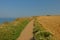 Sandy hiking trail along a field on the ciffs on the French Northe sea coast,