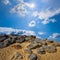 Sandy hill with huge stones at  sunny day