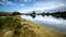 Sandy hills. Lake in the Sandy canyon. Warm colors background. Yellow sandstone textured mountain, white thin sand dune, bright sk