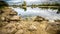 Sandy hills. Lake in the Sandy canyon. Warm colors background. Yellow sandstone textured mountain, white thin sand dune, bright sk