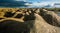 Sandy hills. Sandy canyon. Warm colors background. Yellow sandstone textured mountain, white thin sand dune, bright sky.