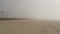 Sandy misty beach California USA. Pacific ocean coast dense fog on sea shore. Milky smog brume haze