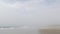 Sandy misty beach California USA. Pacific ocean coast, dense fog on sea shore. Waves in brume haze.